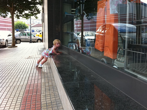 Cleaning dust off the ledge with her dress